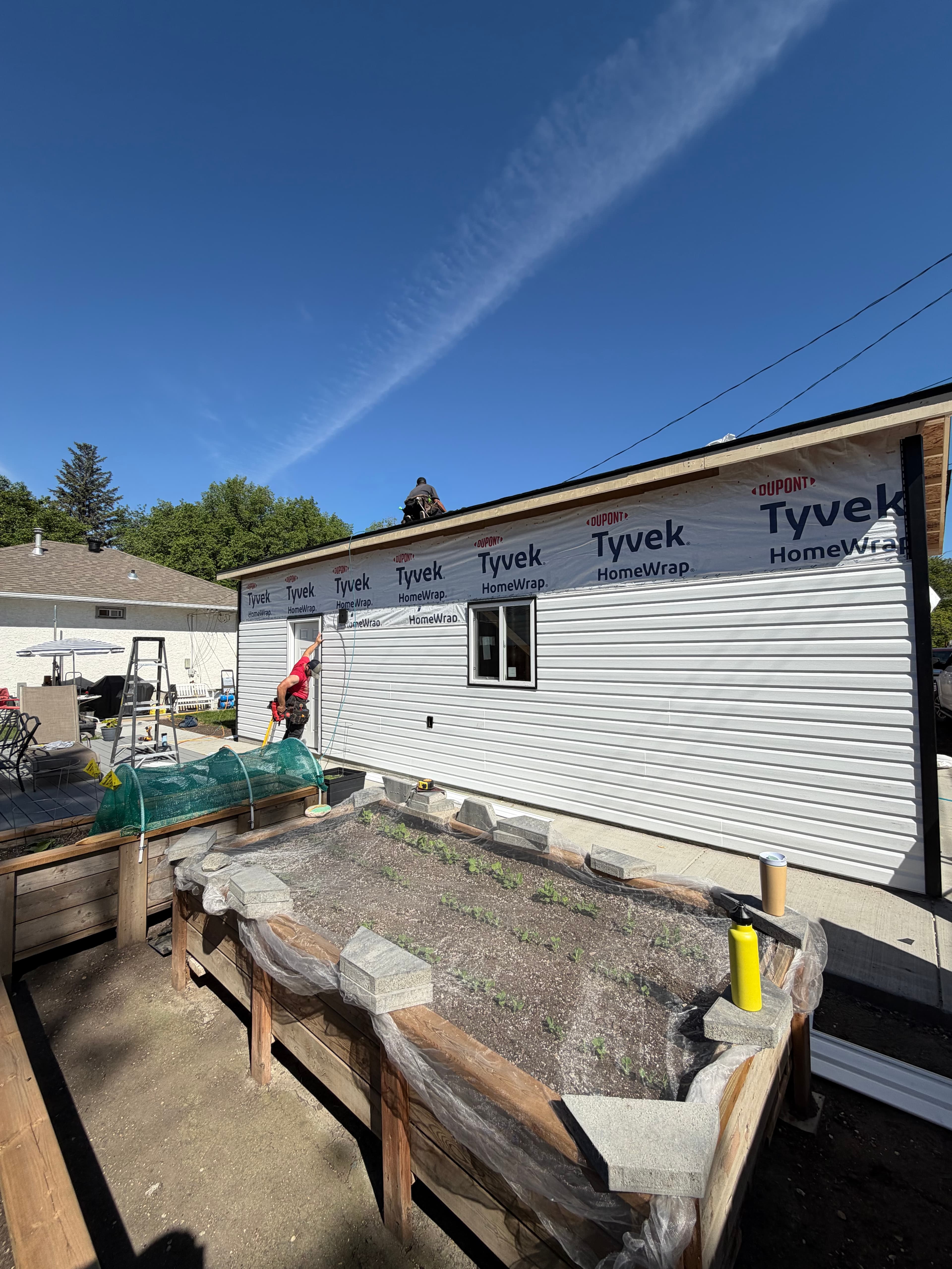 WLG Homes crew building a full detached garage in Saskatoon - siding installation in progress