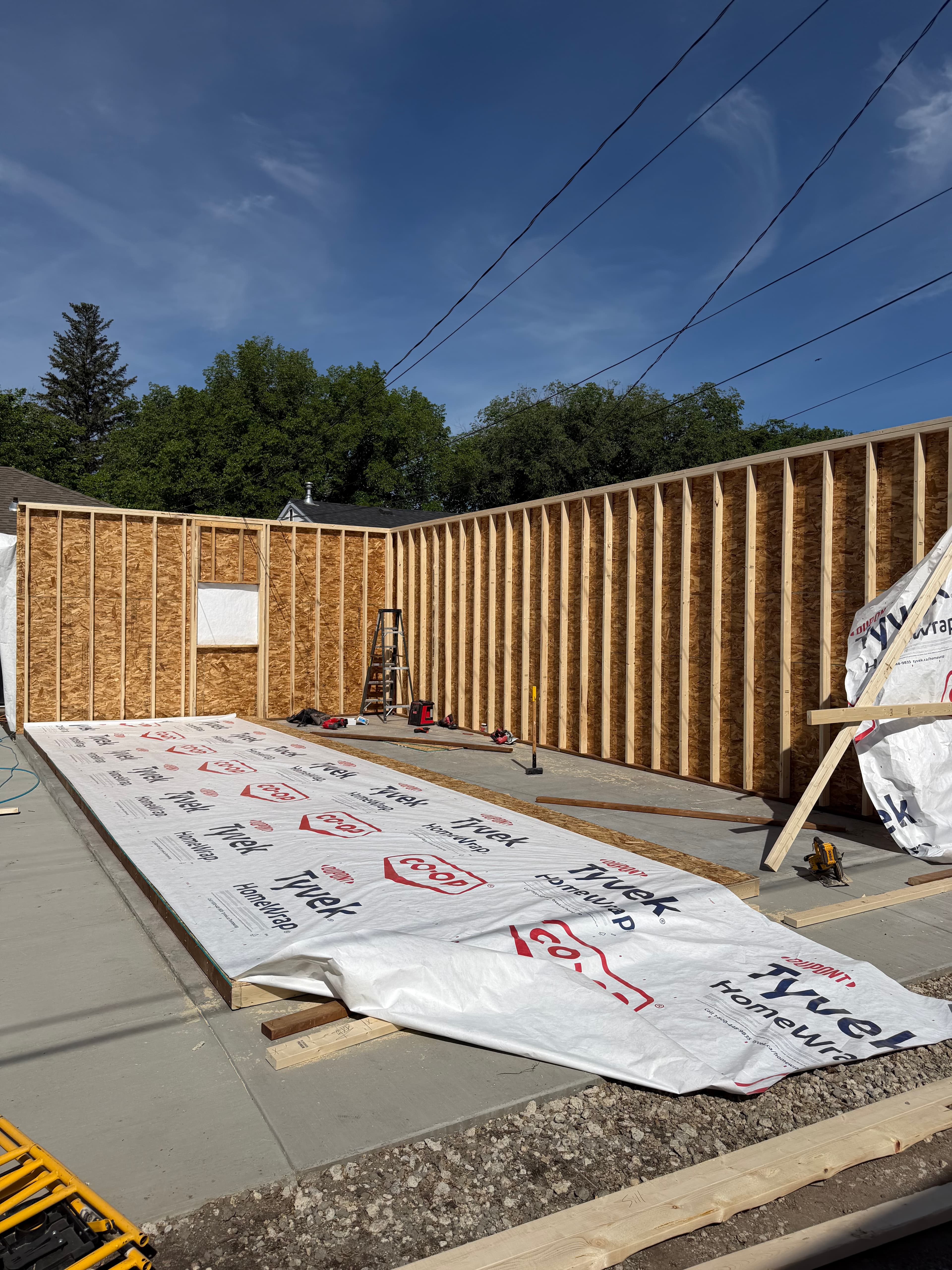 Completed roof framing with Tyvek house wrap beginning on walls of Saskatoon garage build